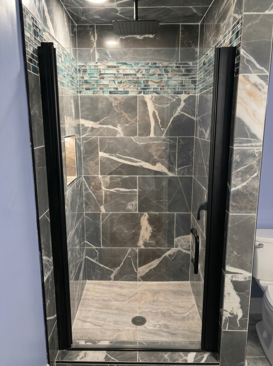 Dark marble walk-in shower with teal accent tile